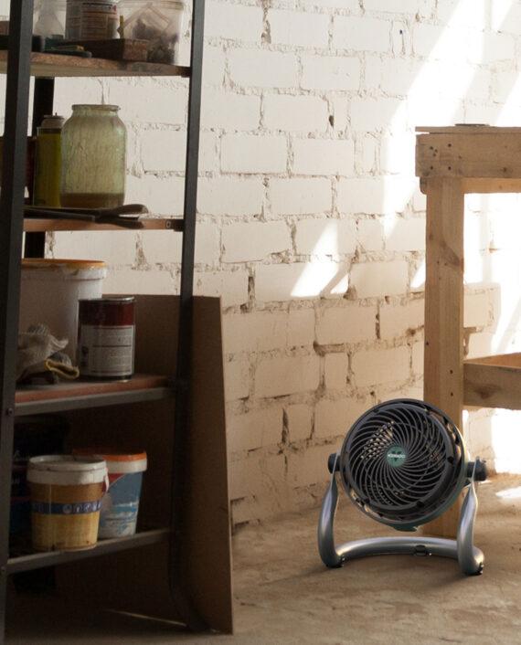 EXO51 Heavy Duty Small Air Circulator on a concrete floor in an artist's studio.