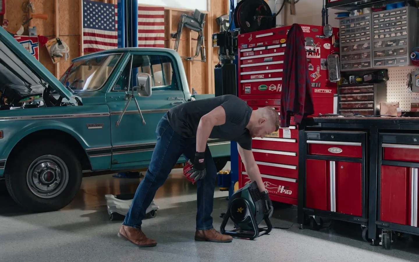 man using rtr hd in garage next to truck