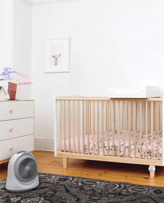 Lifestyle of a Sensa cribside Sensing Nursery Heater with Auto Climate near a crib in a nursery